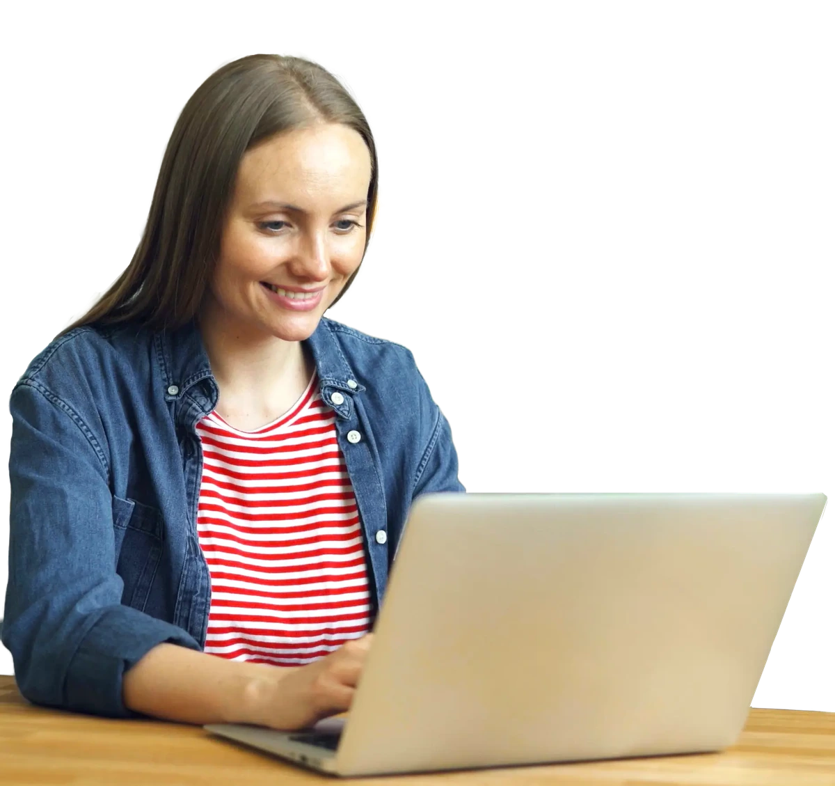 A woman smiling while using her laptop